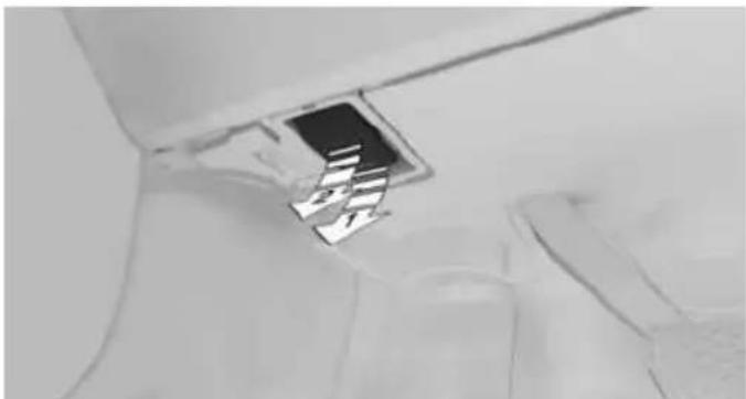 Close-up of a small electronic component or device with a metallic square and rectangular lens, placed on a surface (no visible text or symbols)