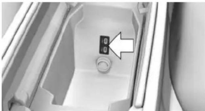 Interior view of a refrigerator with a button and indicator light (no text or symbols visible)