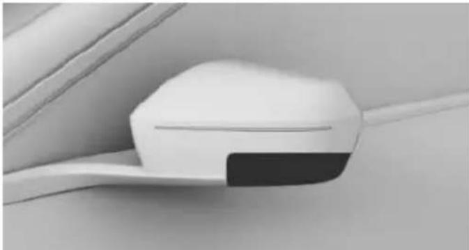 Close-up of a white electronic device with a black tab, mounted on a white surface (no visible text or symbols)
