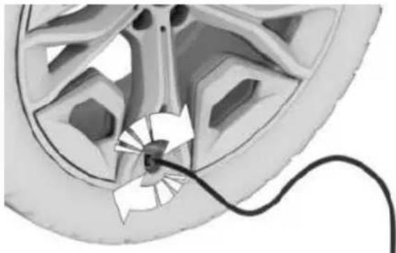 Diagram of a car wheel with a cable inserted, showing internal components and a directional arrow (no text or symbols)