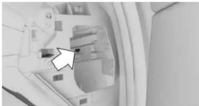 Interior view of a vehicle showing a mounted device with a white arrow pointing to a component (no visible text or symbols)