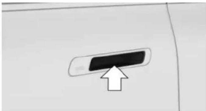Close-up of a door handle with a black rectangular button and an upward arrow pointing to it (no text or symbols)