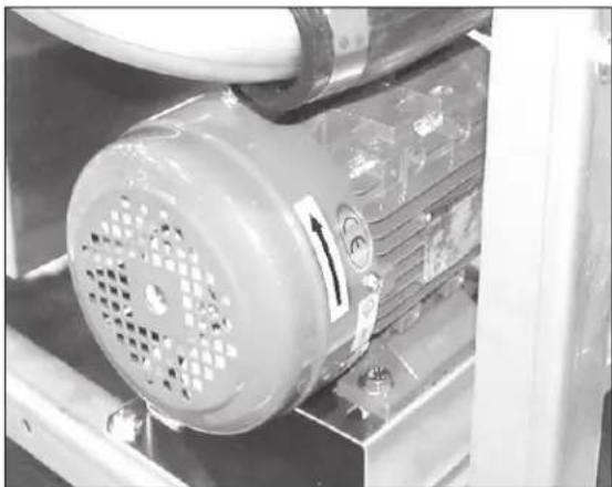 Close-up of an industrial machine with a perforated fan and control panel, showing no visible text or symbols.