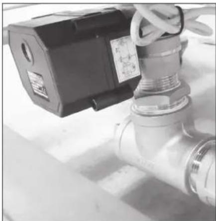 Close-up of a mechanical valve with attached power supply unit (no visible text or symbols)