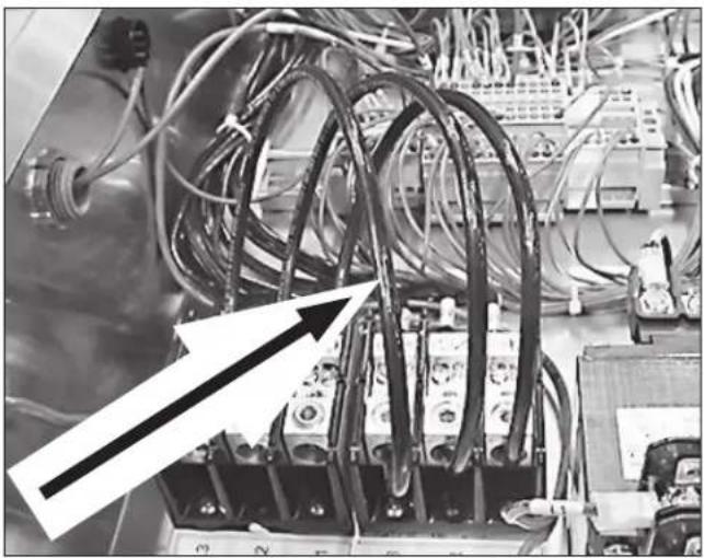 Close-up of electrical equipment with coiled wires and connectors (no visible text or symbols)