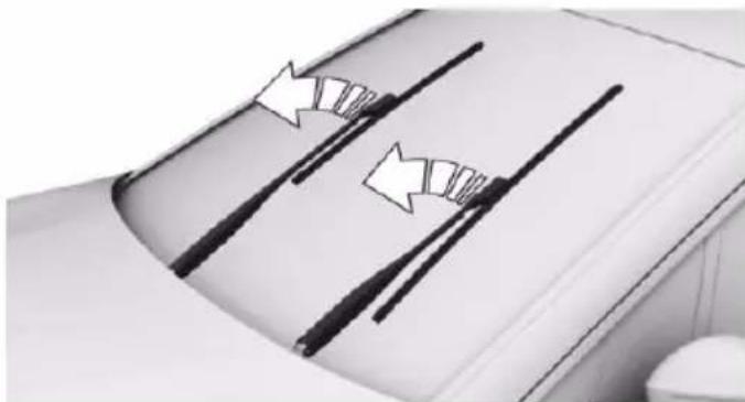 Close-up of a car's roof with visible tire tracks and white arrows indicating motion or movement (no text or symbols)