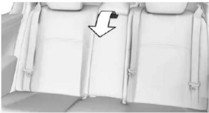 Interior view of a car backrest with white seat covers and a black arrow pointing to the side panel (no text or symbols)