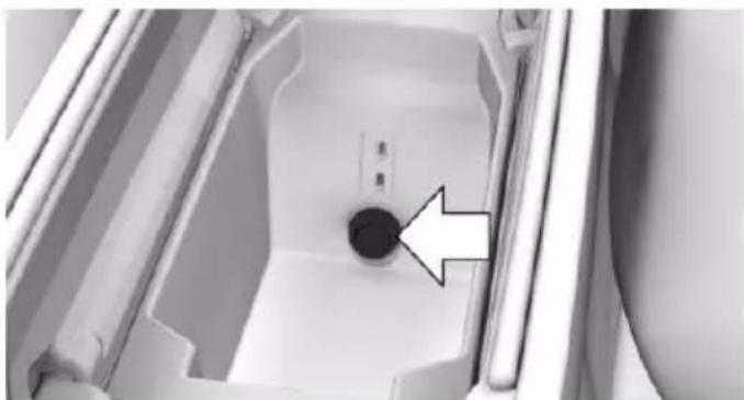 Interior view of a refrigerator with a circular vent and an arrow pointing to the interior (no text or symbols visible)