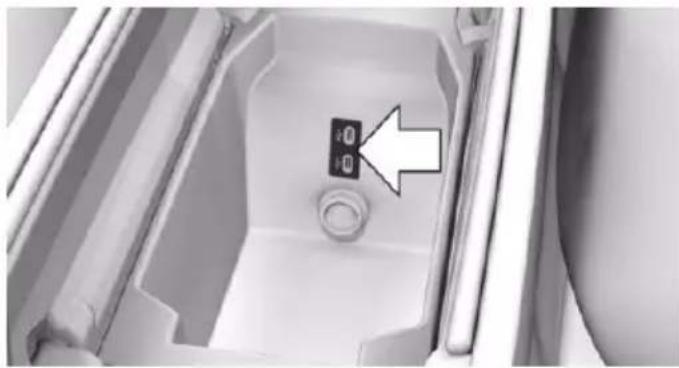 Interior view of a refrigerator sink with a small electronic device on the lid (no text or symbols visible)