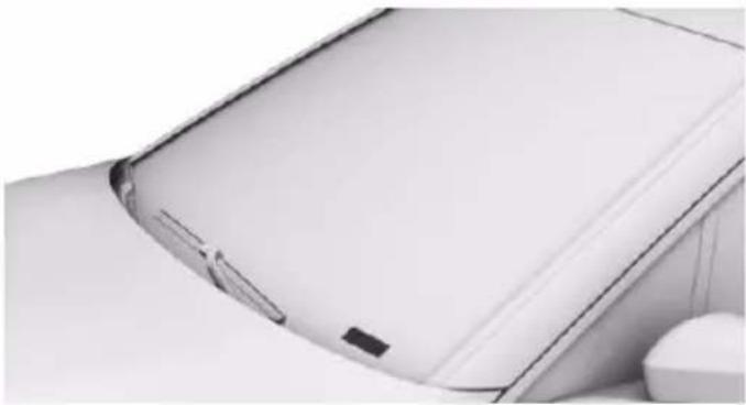 Close-up of a white electronic device with a curved edge and a small black clip, no visible text or symbols.