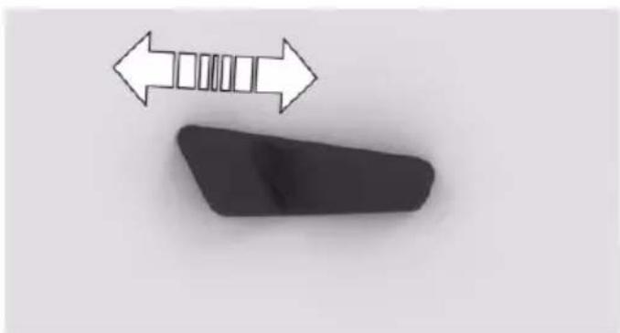 Simple diagram showing a black object with a white double-headed arrow pointing left, and a gray rectangular shape below (no text or symbols)