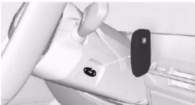 Interior view of a car dashboard with steering wheel and attached black pad (no visible text or symbols)
