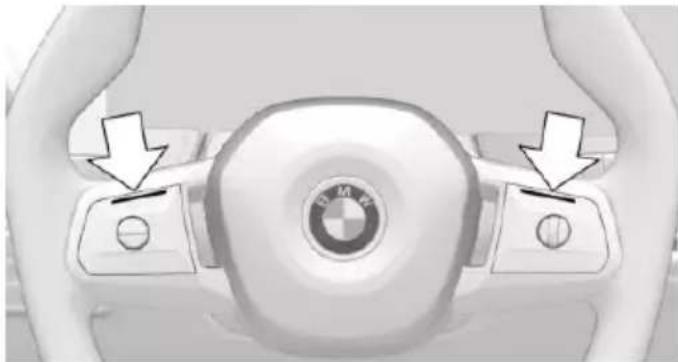 Top-down view of a car steering wheel with BMW logo and directional arrows indicating control buttons (no text or symbols)