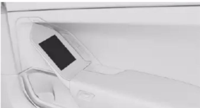 Close-up of a car's front wheel and side door, showing a black rectangular component (no text or symbols visible)