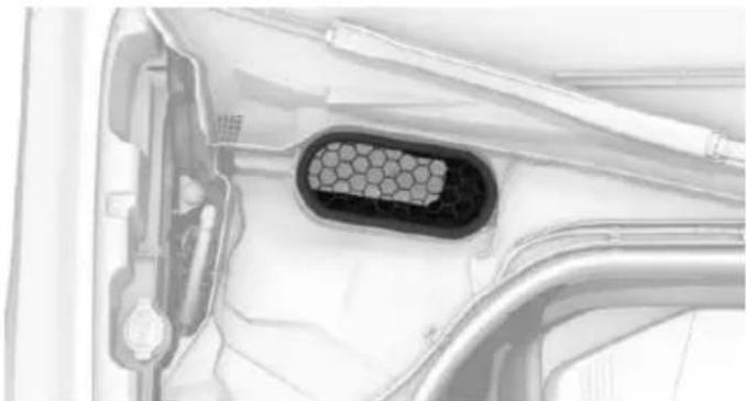 Close-up of a car's front and side panels showing a hexagonal vent or grille (no text or symbols visible)
