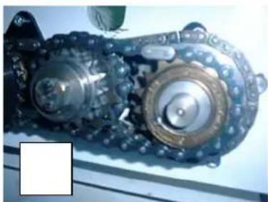 Close-up of a mechanical chain with visible gears and springs (no text or symbols)