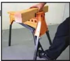 Person assembling a wooden table frame (no visible text or symbols)
