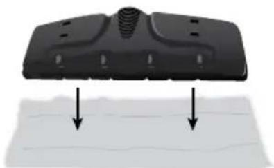 Close-up of a black plastic component with two downward arrows pointing to a textured surface (no text or symbols visible)
