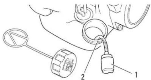 Technical diagram showing a mechanical assembly with labeled parts 1, 2, and a circular component with a connector.