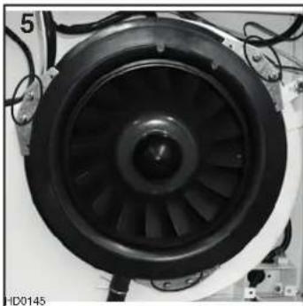 Close-up of a black and white industrial fan or turbine component with visible blades and wiring (no text or symbols)
