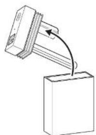 Simple line drawing of a mechanical component with an arrow indicating rotation or assembly (no text or symbols)