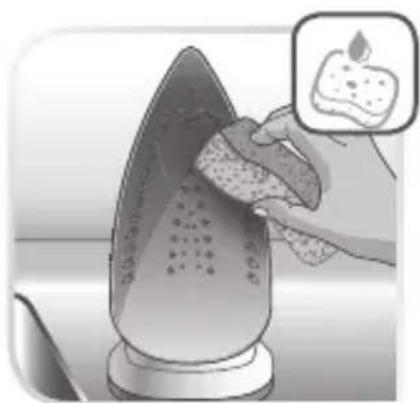 Illustration of a hand using a sponge to clean or wash a steaming iron, with a magnified inset showing the same material (no text or symbols present)
