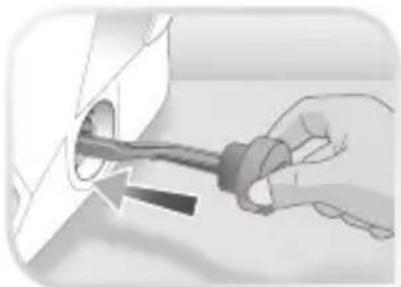 Hand holding a tool with a circular component inserted into a pipe (no text or symbols visible)