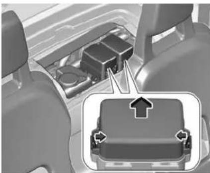 Interior view of a vehicle showing a mechanical component with directional arrows indicating movement or force (no text or symbols present)