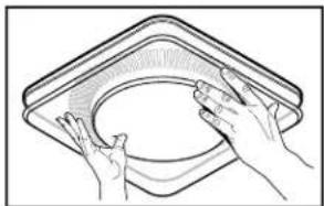 Line drawing of two hands holding a circular object inside a square frame (no text or symbols)