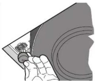 Illustration of a hand holding a small object over a curved surface (no text or symbols visible)