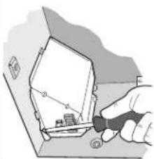 Illustration of a hand using a tool to cut or mark a mechanical component (no text or symbols visible)