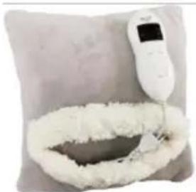 Close-up of a white medical thermometer placed on a textured gray pillow with a white foam cup, no text or symbols visible.