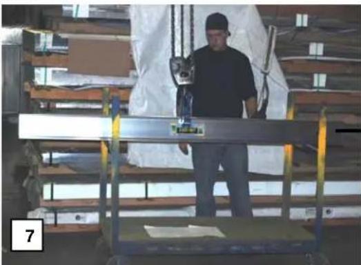 Interior view of a workshop with a person standing beside a metal shelving unit, no visible text or symbols