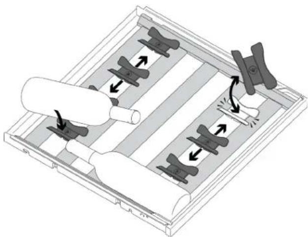 Diagram of a mechanical assembly with rollers and clamps, showing directional arrows indicating movement (no text or symbols)