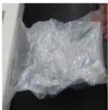 Close-up of a hand holding a transparent plastic bag, no visible text or symbols