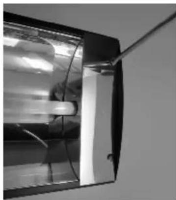 Close-up of a glass door with a metal rod inserted, showing internal components (no text or symbols visible)