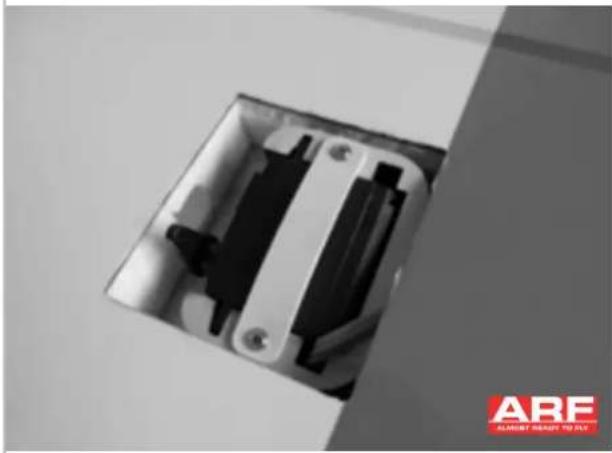 Close-up of an open electrical socket with black and white components, no visible text or symbols