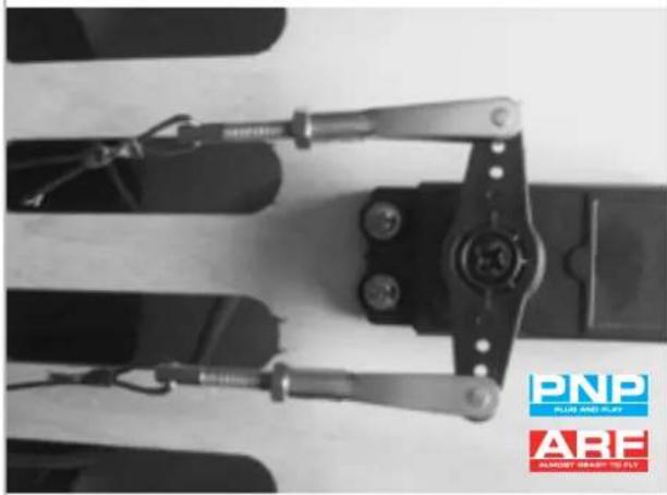 Close-up of a mechanical linkage device with visible springs and components, no text or symbols present.