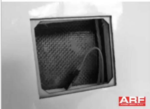 Interior view of a square vent or vent with a mesh pattern on the wall, no visible text or symbols.
