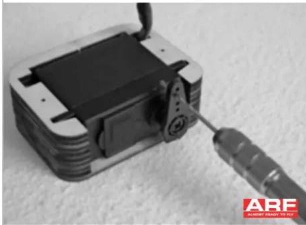 Close-up of a black electronic device with a screwdriver inserted, no visible text or symbols on the device itself.