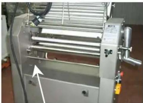 Industrial machine with metal frame and control panel, no visible text or symbols