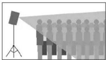 Silhouette of a group of people standing under a spotlight, with a camera on a tripod nearby (no text or symbols)