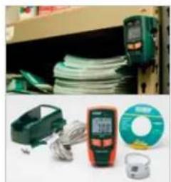 Product display of electrical testing equipment including capacitors, televisions, and a coiled cable (no visible text or labels)