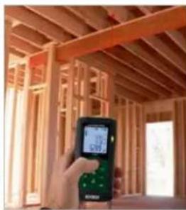 Interior view of a wooden house with exposed beams and a digital display (no visible text or symbols)