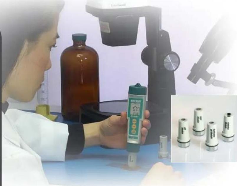Scientist in lab coat examining a BRIEGY device with microscope equipment in background (no visible text or symbols)
