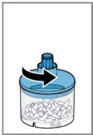 Illustration of a blue plastic container with a black arrow indicating rotation or flow, containing scattered fragments.