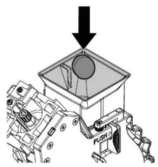 Mechanical assembly diagram showing a device with a circular component and an arrow indicating downward motion (no text or symbols present)