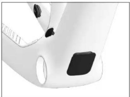 Close-up of a white ergonomic device with black buttons and a circular handle (no visible text or symbols)