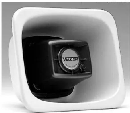 Close-up of a white plastic container with a black valve labeled 'VALCOM' on its side (no additional text or symbols visible)