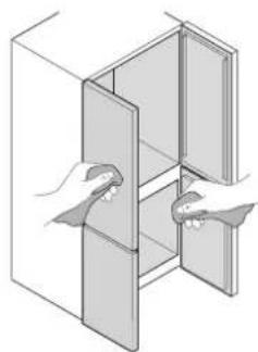 Illustration of two hands inserting a rectangular panel into a cabinet (no text or symbols)